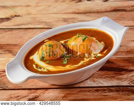 Anda Masala Or Egg Curry Is Popular Indian Spicy Food, Served In A Ceramic Bowl Over Rustic Wooden B
