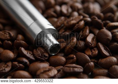 E-cig Device Mod Lies On The Background Of Coffee Beans. Concept Of Vape Coffee Juice