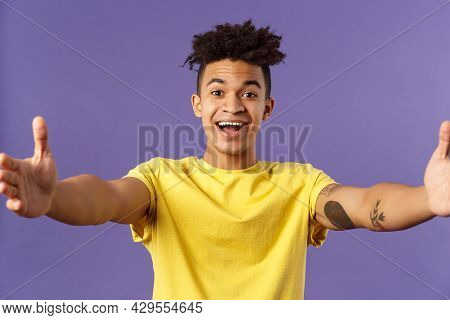 Close-up Portrait Of Friendly Cheerful Young Hispanic Hipster Guy Giving Warm Welcome To Dearest Gue