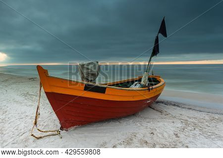 A Fishing Wooden Boat Moored By The Beach In Debki, Sunrise. Baltic Sea, Northern Poland.