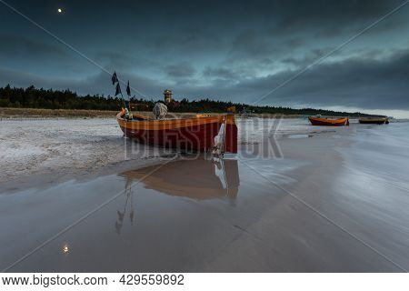 A Fishing Wooden Boat Moored By The Beach In Debki, Sunrise. Baltic Sea, Northern Poland.