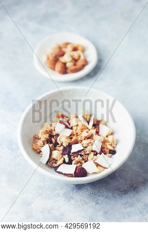 Bowl Of Granola With Nuts, Cranberry And Cocoanut. Concept For A Tasty And Healthy Meal. Stone Backg