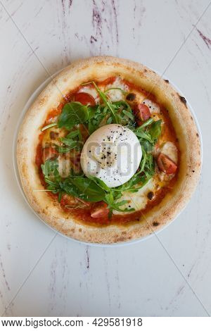 Buratta Cheese On A Neapolitan Pizza On A Cafe Table