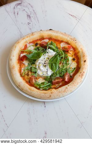 Buratta Cheese On A Neapolitan Pizza On A Cafe Table