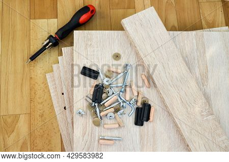 Chipboard Sheets, Tools And Parts For Assembly Of Cabinet Furniture. Self-assembly Of Furniture At H