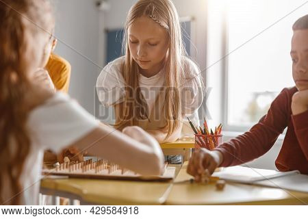 Kids Using Geoboard Together In Classroom In School