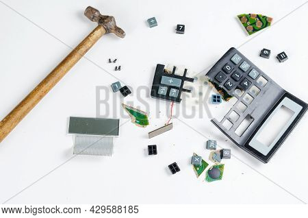 Hammer And Broken Into Pieces Calculator On White Background. Buttons, Body Pieces, Board, Display, 