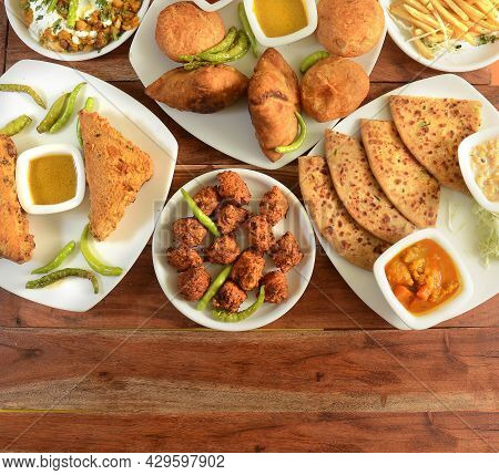 Assorted Indian Tea Time Snacks In Group Includes Spicy Onion Fritters, Bread Pakora,samosa, Kachori