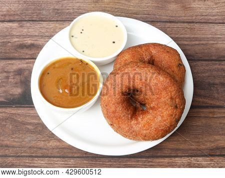 Indian Fried Snack Medu Vada With Sambar And Coconut Chutney In Plate On Rustic Wooden Background, S
