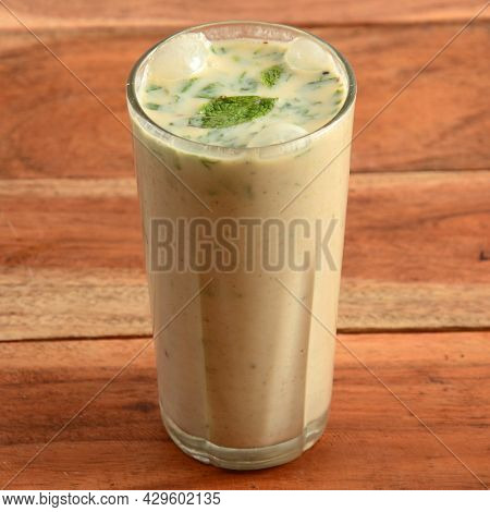 Masala Buttermilk Drink Or Masala Chaas, Made Of Yogurt. Served In A Glass Over A Rustic Wooden Back