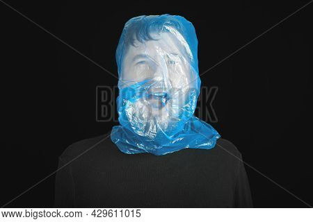 Suicide Bag On Man Head. Exit Bag For Suicide. Self-asphyxiation Concept. Garbage Bag On Head. Short
