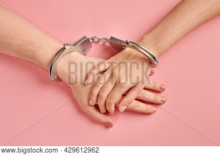 Male And Female Hands In Handcuffs. Love Forever. Prenuptial Agreement, Duties Of Love Couple.