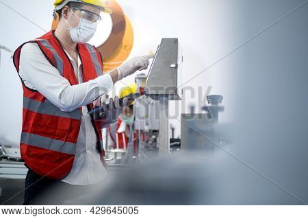 Quality Control (qc) Engineer Monitoring And Checking Machine System In Manufacturing Factory