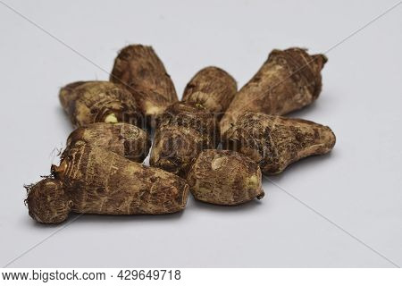 Whole Taro Root Or Colocasia Esculenta Raw Root Vegetable Also Known As Arbi In India On White Backg