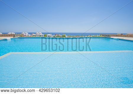Large Outdoor Infinity Swimming Pool At A Luxury Tropical Hotel Resort With Sea View
