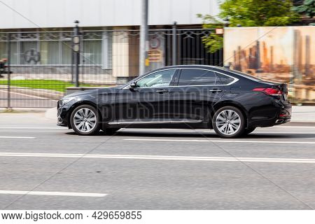Genesis G80 On The Street In Motion. Side View Of A Premium Korean Car, Luxury Black Sedan. Moscow, 
