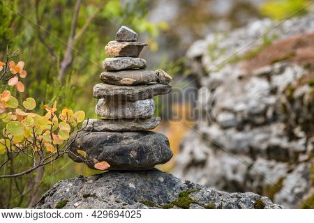 Balance stones on the rock in autumn forest. Concept of balance and harmony