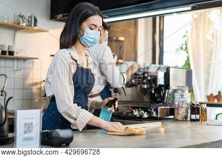 Cafe Waiter Wear Mask, Clean Restaurant With Sanitizer To Open Store. Asian Attrctive Young Couple D