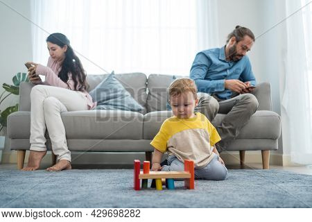 Caucasian Phone Addict Parents Don't Pay Attention With Baby Toddler. Family Problem, Father And Mot