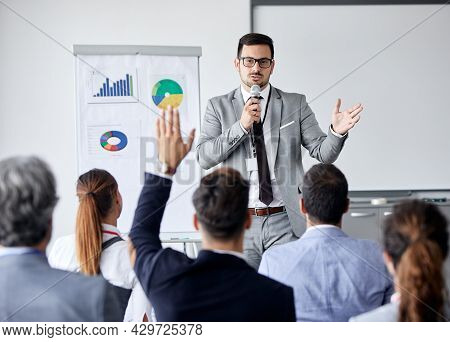 Young Busnessman Having A Speech By A Whiteboard During A Conference Business Meeting In An Office. 