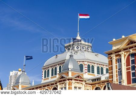 Scheveningen, The Netherlands - Apr 26, 2021: Flags On Top Of The Famous Kurhaus Hotel In Schevening