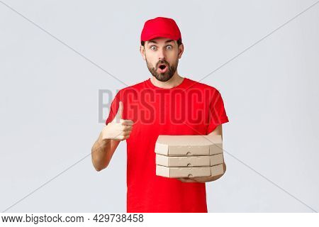 Food Delivery, Quarantine, Stay Home And Order Online Concept. Surprised And Amazed Bearded Courier 