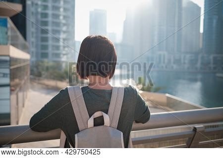 Happy Young Female Traveler In The Big City Of Dubai, Famous Place Dubai Marina. Luxury And Comforta