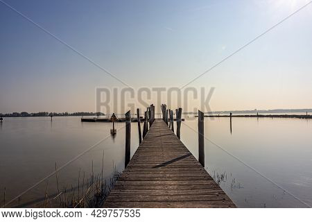 Straight Wooden Bridge Between Calm Waters Towards The Recreation Area In The Atoll At Woldstrand Ze