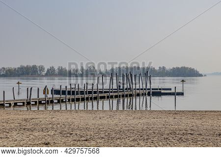 Wooden Platform Among Calm Waters With Mature Woman Filming With Her Mobile Phone, Enjoying A Sunny 