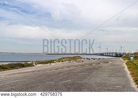 Street Towards The Delta Works In The Rhine-meuse-scheldt Delta With Windmills In The Background. Da