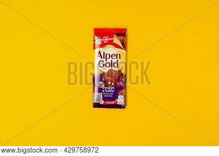 Tyumen, Russia-may 25, 2021: Alpen Gold Chocolate With Hazelnuts And Raisins On A Yellow Background