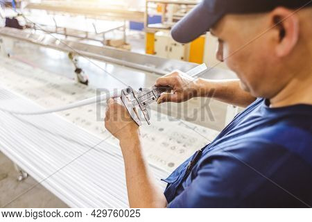 Factory Worker Engineer Checks The Quality Of Polypropylene Pipes