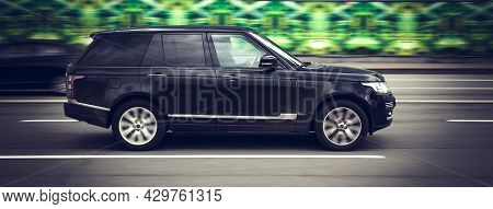 Outdoor Photo Of Range Rover L405 On The Street. Black Premium Suv In Motion, Side View. Moscow, Rus