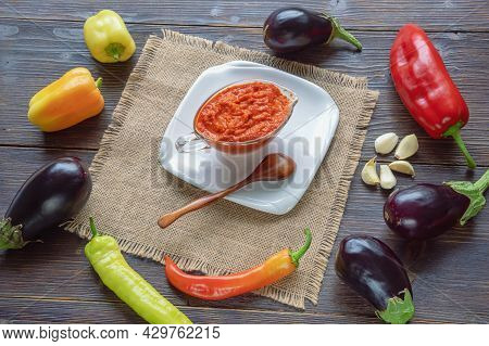 Balkan Cuisine. Ajvar - Condiment Or Snack Made From Bell Peppers, Eggplants, Garlic - On Dark Rusti