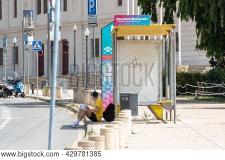 Barcelona, Spain; August 12 2021: Men Wait The Touristic Bus In Montjuic Olympic Stadium, Built In 1