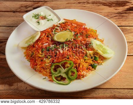 Tawa Pulao Cooked With Masala Spices, Served Over A Rustic Wooden Background, Selective Focus
