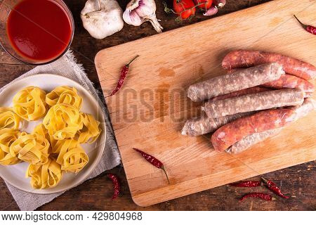 Cooking American Pasta With Sausage Stew, Pasta With Sausage Ragu.  Ingredients On The Table - Two T