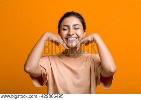 Close Up Portrait Of Young Indian American Woman Doing Facebuilding Yoga Face Gymnastics Yoga Self M