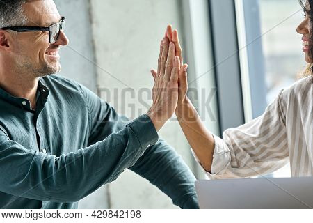 Two Happy Multiethnic Professional Executive Businessman And Businesswoman Coworkers Giving Highfive