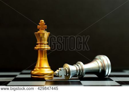 Gold King Chess Piece Win Over Lying Down Silver King On Black Background