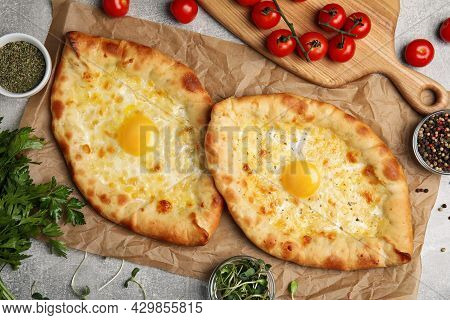 Fresh Delicious Adjarian Khachapuris Served On Grey Table, Flat Lay