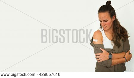 Coronavirus Vaccination Advertisement. Vaccinated Woman Showing Arm With Plaster Bandage After Covid