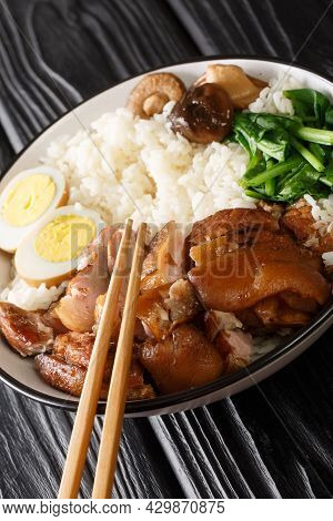 Stewed Pork Leg With Rice, Eggs And Herb Thai Khao Kha Moo Closeup In The Bowl On The Table. Vertica