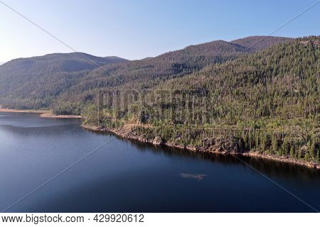 Aerial View Of Lake Granby, Colorado And Surrounding Mountains And Forests On Clear Calm Summer Morn