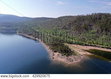 Aerial View Of Lake Granby, Colorado And Surrounding Mountains And Forests On Calm Sunny Summer Morn