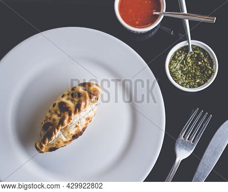 Traditional Argentinian Food Called Empanada In A Restaurant From A Top View