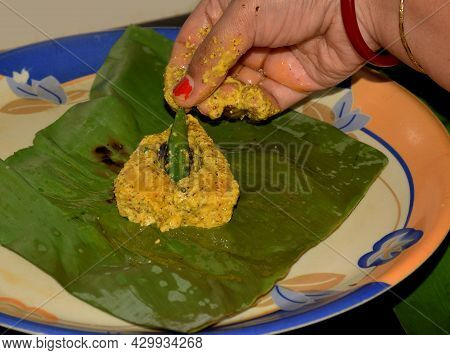 Bengali Women Preparing Ilish Paturi Dish Where Fish Is Smeared With Mustard Oil And Poppy Seeds Bef