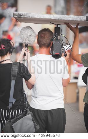 Behind The Scenes. Film Crew Team Shooting Movie Scene On Outdoor Location. Group Filmmaking Set Pro