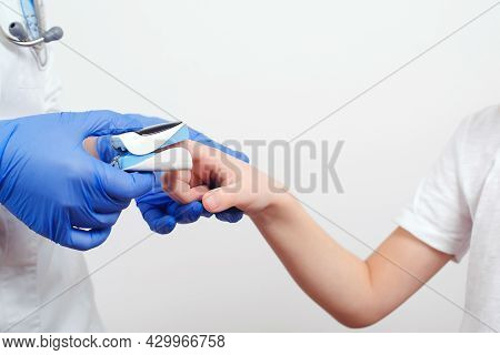 Doctor Measures The Patient's Pulse And Oxygen Saturation To Young Boy. Concept Of Detection Of Asym