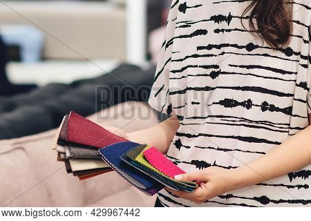 Woman Chooses The Colors And Patterns Of Upholstery Fabrics. Textile Industry Background. Tissue Cat